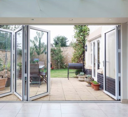 White-Bi-folding-Door-Open-to-Yard-With-One-Panel-to-Right
